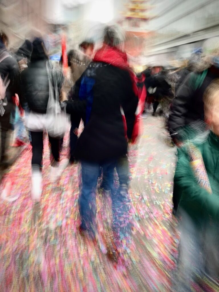 Woman in red scarf explores city streets in Chinatown, NYC 